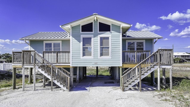 rear view of property featuring a carport and a porch