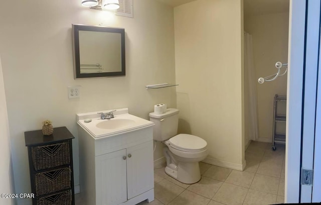 bathroom with tile patterned floors, vanity, and toilet