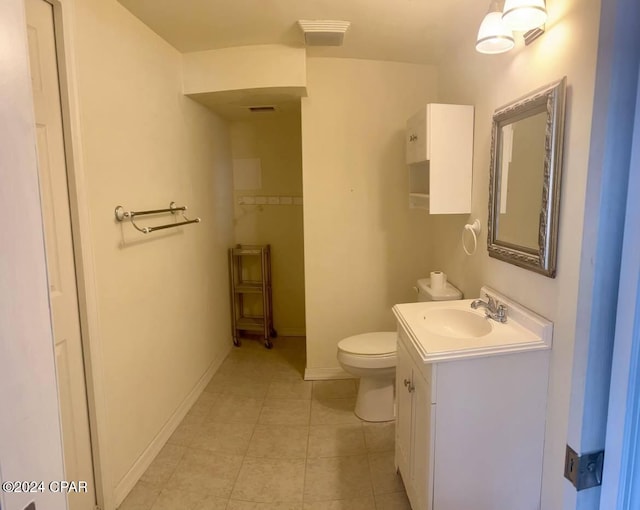 bathroom with vanity, tile patterned floors, and toilet