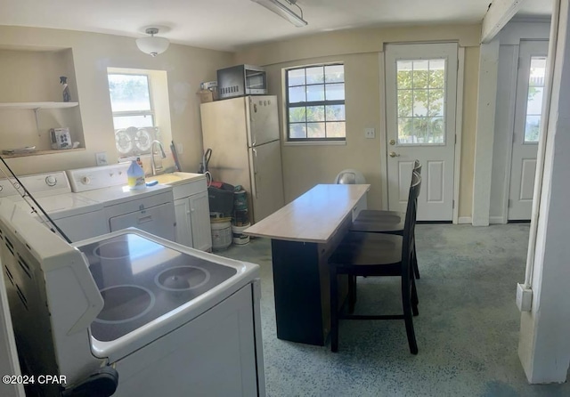 kitchen featuring white cabinets, washer / dryer, sink, and white refrigerator