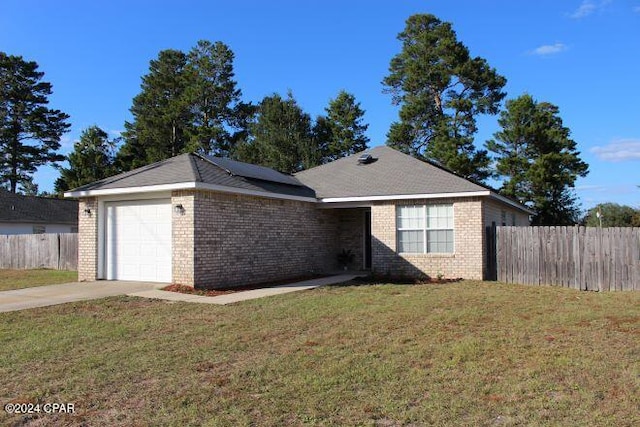 view of front of house featuring a front yard and a garage