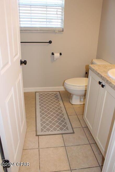 bathroom featuring toilet, vanity, and tile patterned floors