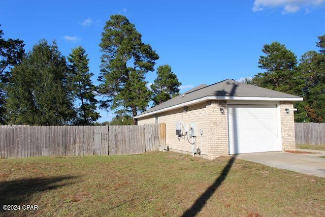 view of property exterior featuring a garage and a lawn