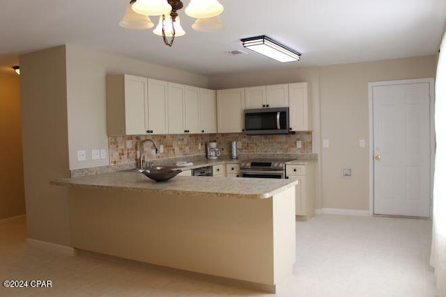 kitchen with white cabinetry, stainless steel appliances, decorative backsplash, and kitchen peninsula