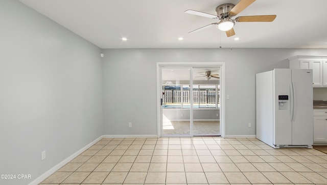 interior space with light tile patterned floors and ceiling fan