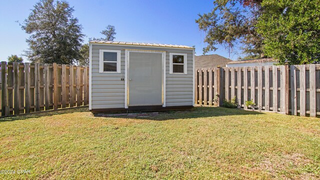 view of outbuilding featuring a lawn