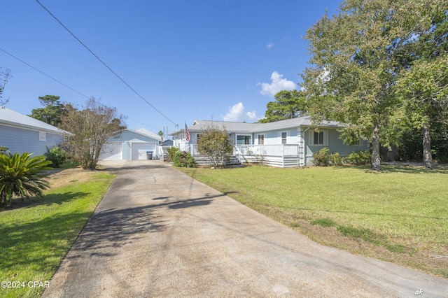 ranch-style house featuring an outbuilding, a front lawn, and a garage