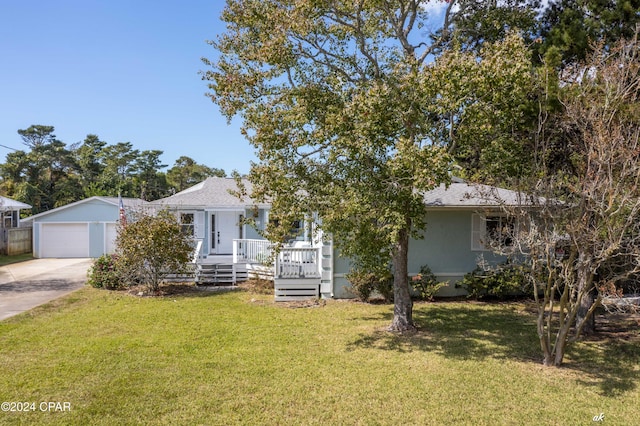 view of front of property featuring an outbuilding, a garage, and a front lawn