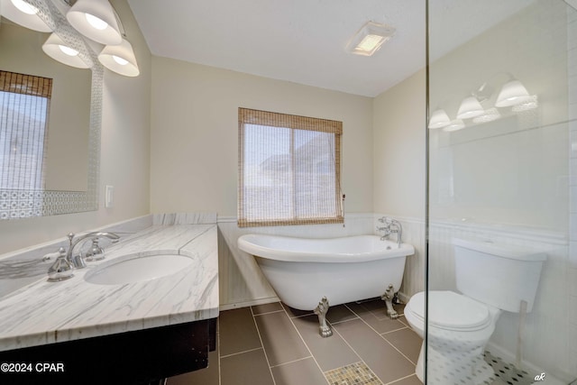 bathroom featuring tile patterned floors, vanity, tile walls, toilet, and a tub