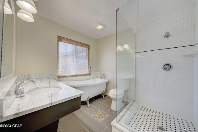 full bathroom featuring tile patterned floors, a textured ceiling, toilet, vanity, and shower with separate bathtub