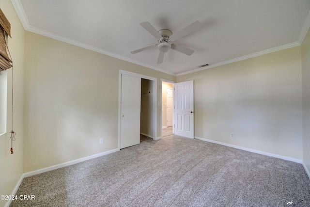 unfurnished bedroom with carpet flooring, ceiling fan, and crown molding