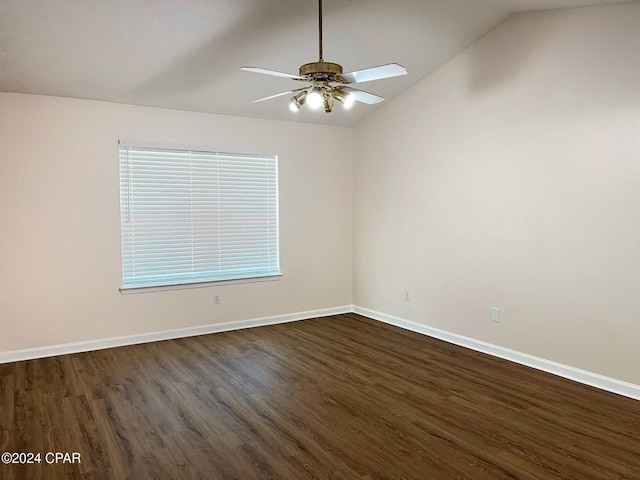 spare room featuring dark hardwood / wood-style flooring, vaulted ceiling, and ceiling fan