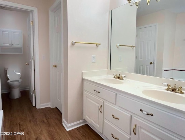 bathroom with vanity, hardwood / wood-style floors, and toilet