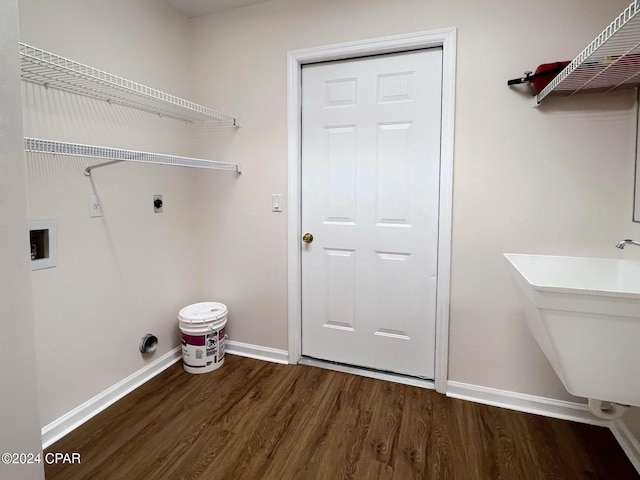 washroom featuring dark wood-type flooring, hookup for an electric dryer, hookup for a washing machine, and sink