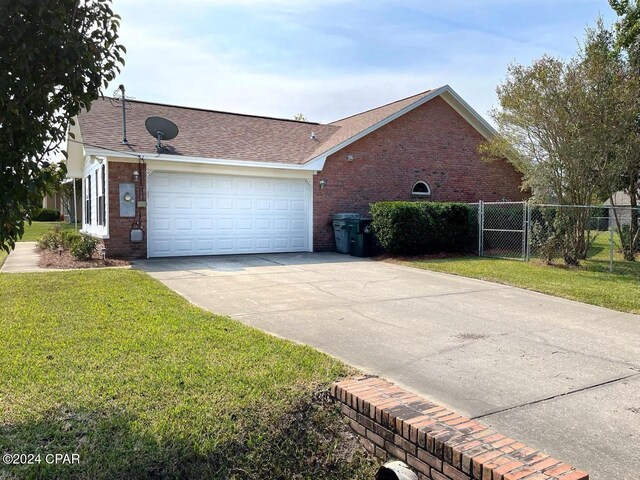 view of home's exterior featuring a yard and a garage