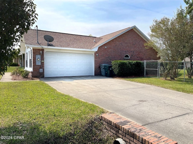 view of side of property featuring a yard and a garage