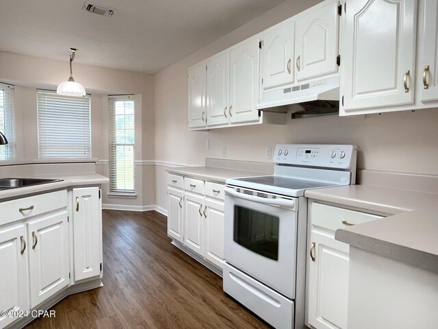 kitchen with electric stove, sink, dark wood-type flooring, white cabinetry, and hanging light fixtures