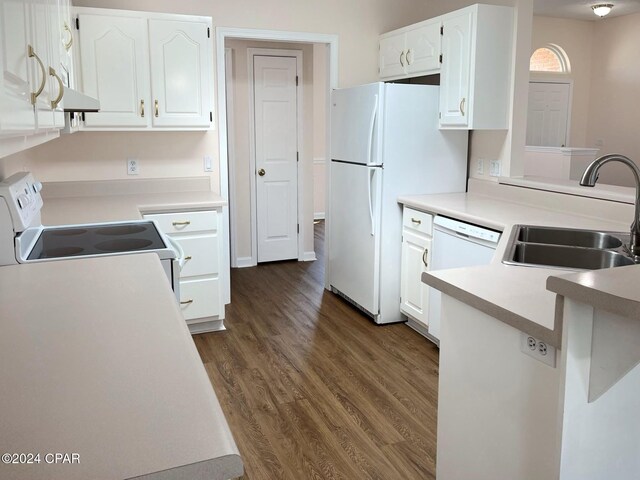 kitchen featuring sink, dark hardwood / wood-style floors, kitchen peninsula, white appliances, and white cabinets