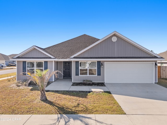 view of front facade with a front lawn and a garage