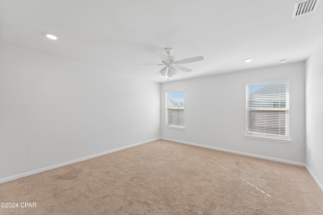 empty room featuring carpet flooring and ceiling fan