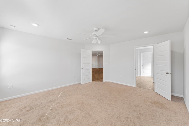 interior space with light carpet and ceiling fan