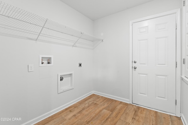 clothes washing area featuring hookup for an electric dryer, hardwood / wood-style flooring, and washer hookup