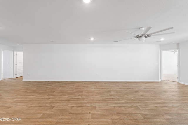 unfurnished room featuring ceiling fan and light hardwood / wood-style flooring