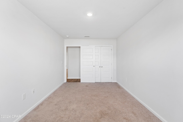 unfurnished bedroom with a closet and carpet