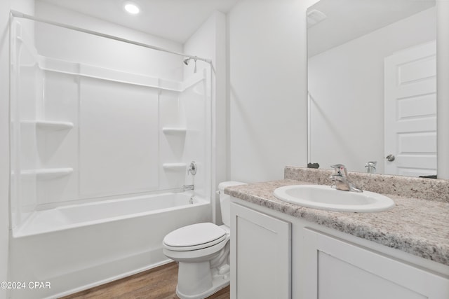 full bathroom with vanity, shower / washtub combination, hardwood / wood-style flooring, and toilet