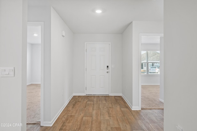 hallway with light hardwood / wood-style flooring