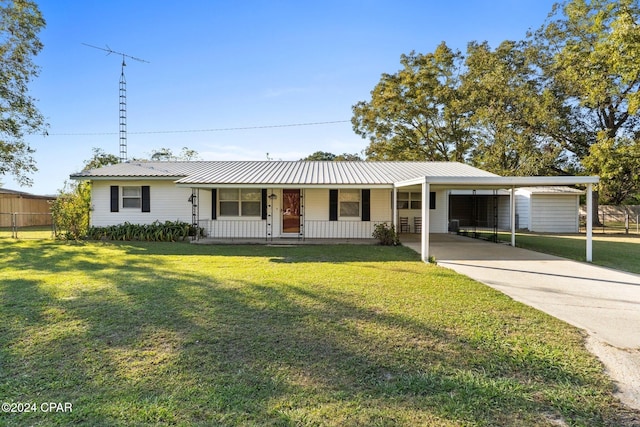 ranch-style home featuring a front yard, covered porch, and a carport