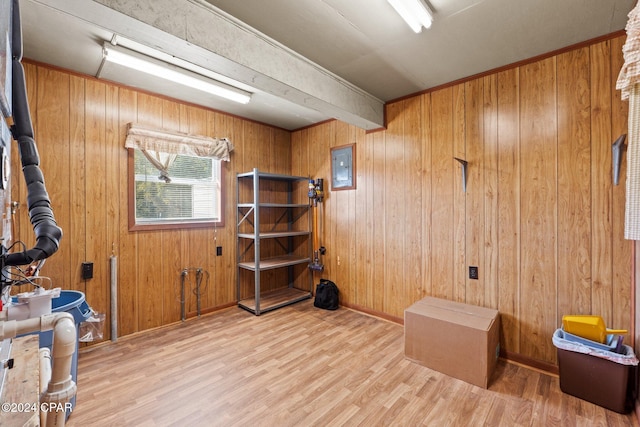 miscellaneous room with wood walls, hardwood / wood-style floors, and electric panel