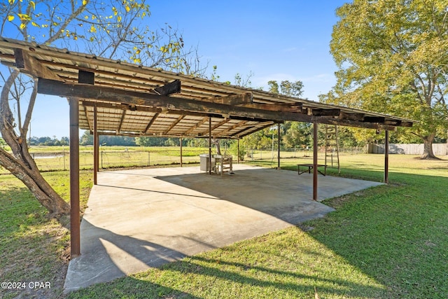 view of property's community featuring a patio area and a lawn