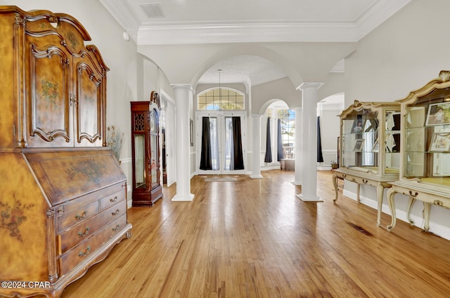 entryway featuring ornamental molding, light hardwood / wood-style flooring, ornate columns, and lofted ceiling