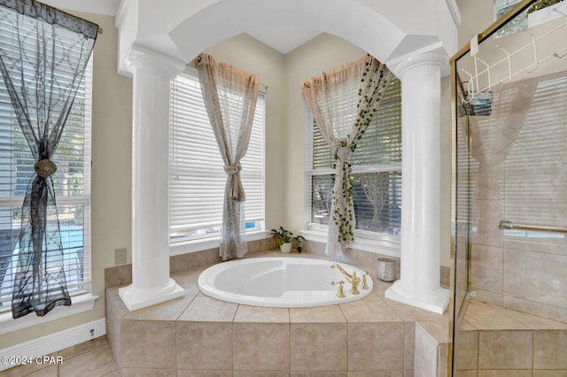 bathroom featuring decorative columns and shower with separate bathtub