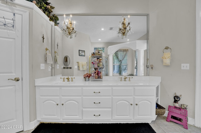 bathroom with vanity, a notable chandelier, and tile patterned floors