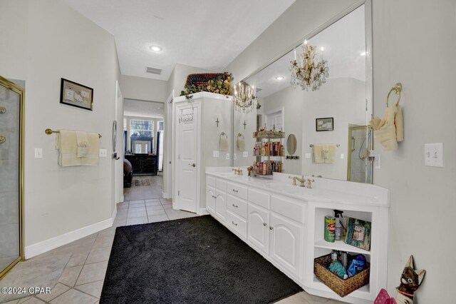 bathroom featuring vanity, walk in shower, and tile patterned flooring