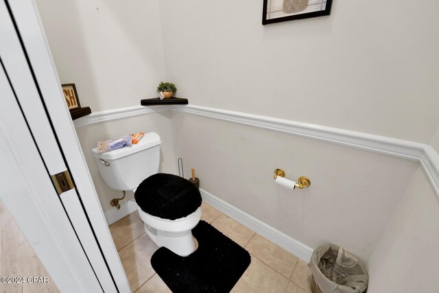 bathroom featuring toilet and tile patterned flooring