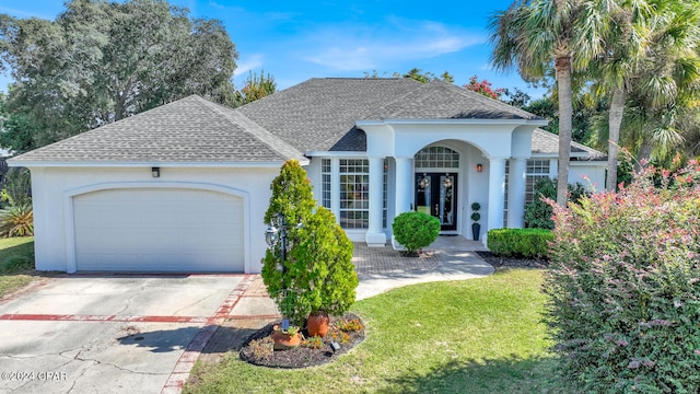 view of front of house with a garage and a front lawn