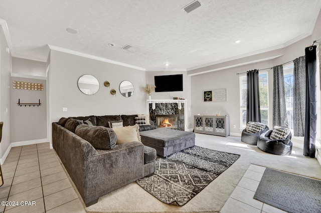 tiled living room with ornamental molding, a high end fireplace, and a textured ceiling