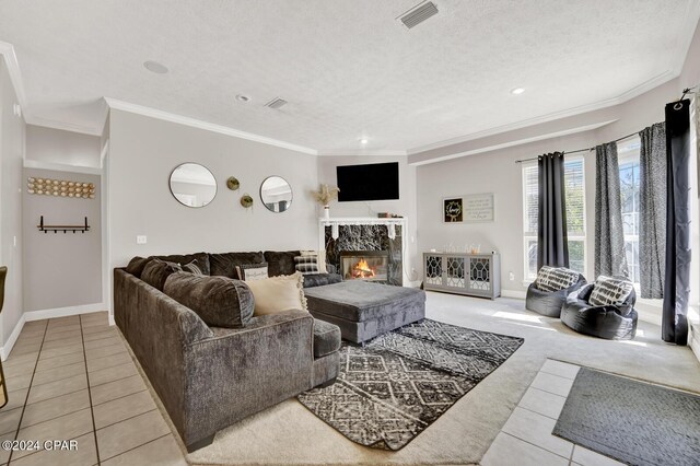 tiled living room with a high end fireplace, a textured ceiling, and ornamental molding