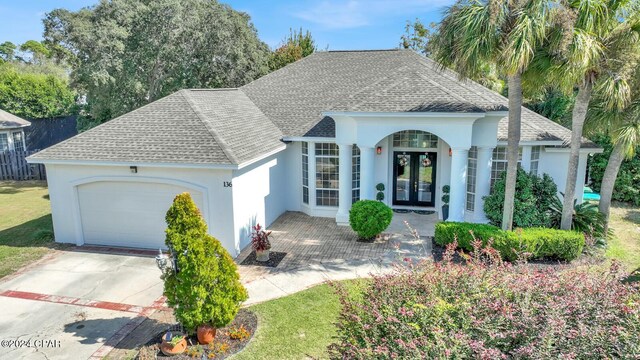 view of front of property featuring french doors and a garage