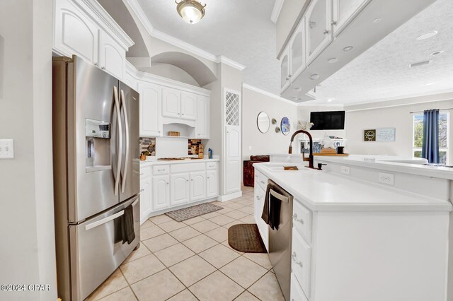 kitchen with sink, appliances with stainless steel finishes, crown molding, and white cabinets