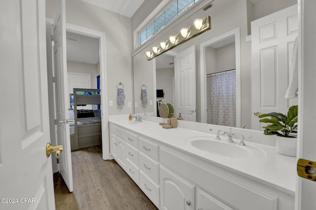 bathroom featuring vanity, curtained shower, and wood-type flooring