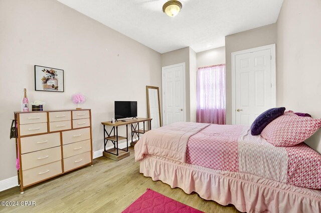 bedroom with wood-type flooring