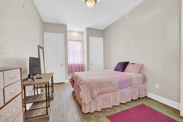 bedroom with wood-type flooring