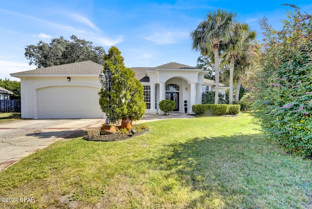 mediterranean / spanish-style home with a front lawn and a garage