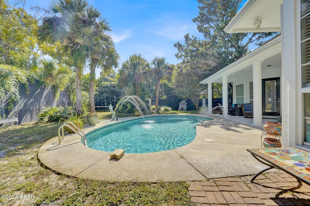 view of swimming pool with a patio area, pool water feature, and an outdoor hangout area