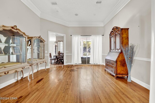 interior space featuring crown molding and light wood-type flooring