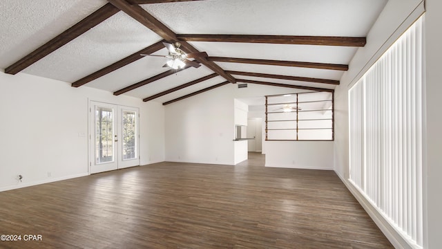 unfurnished living room featuring ceiling fan, lofted ceiling with beams, dark wood-style floors, and a textured ceiling